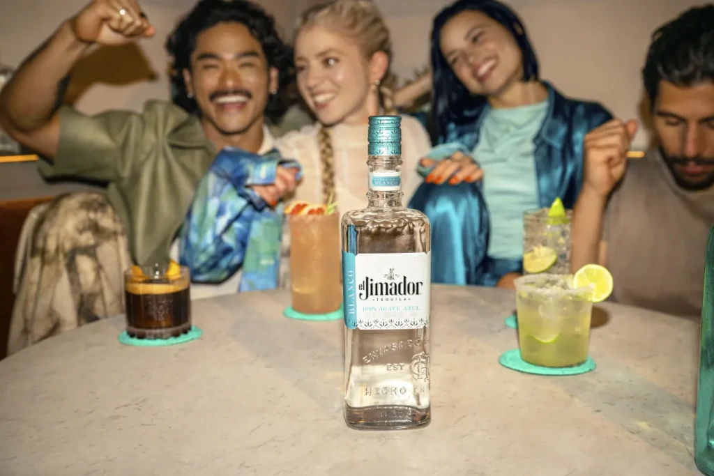 People sitting at a table with el Jimador Tequila on it.